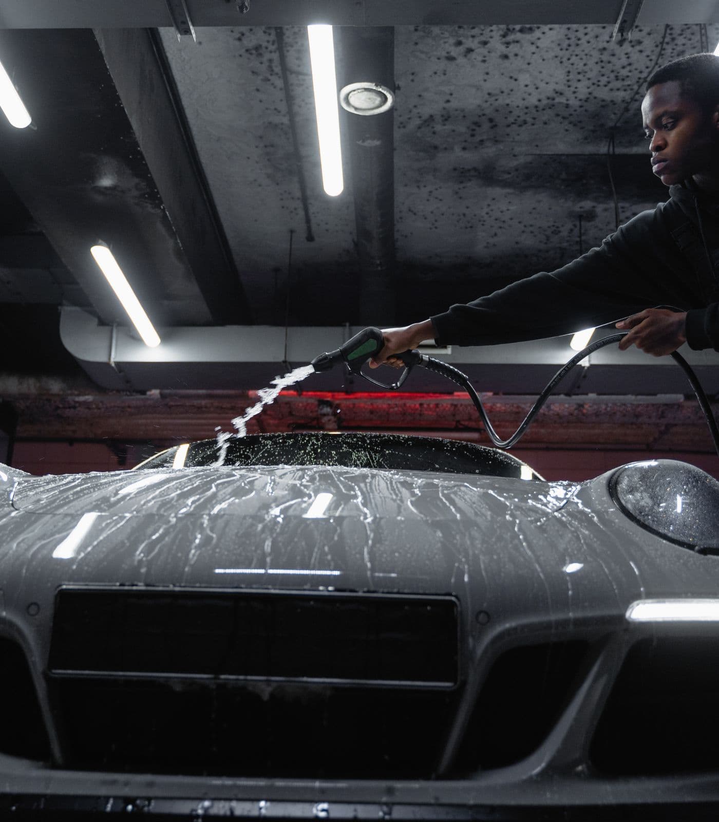 Professional washing a white sports car